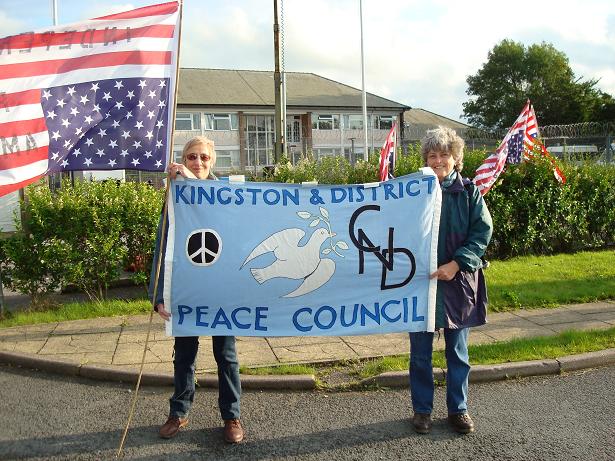 Hilary Evans and Rosemary Addington raise the banner outside Menwith Hill