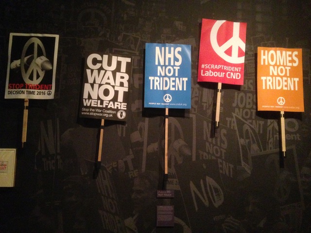 Five peace placards: Stop Trident - Decision time 2016, Cut war not welfare, NHS not Trident, Scrap Trident - Labour CND, Homes not Trident