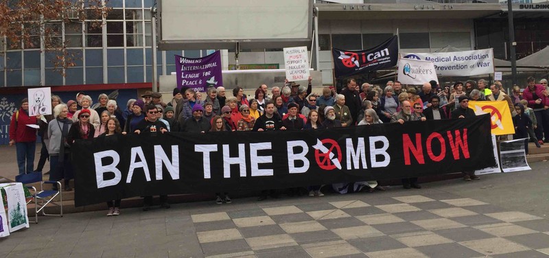 Group of about 80 people holding a banner 'Ban the bomb now'