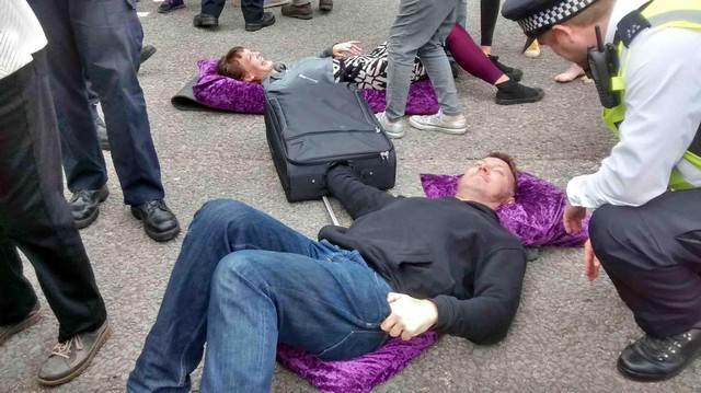More protesters chained together lying in the road