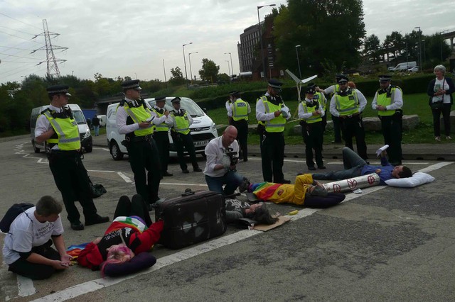 Protesters chained together lying in the road