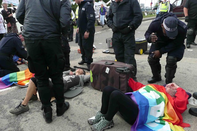 More protesters chained together lying in the road