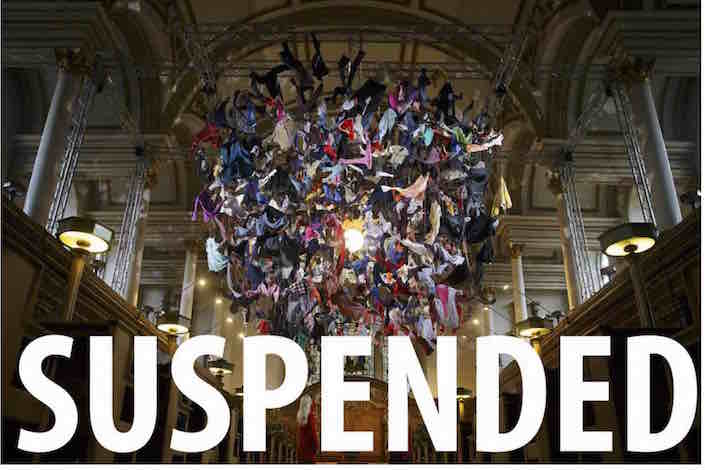 Suspended. Clothes hanging from the ceiling of a church