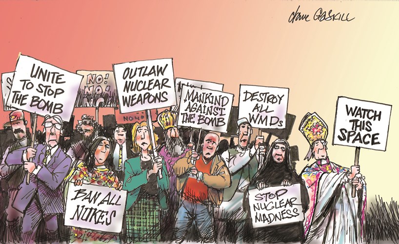 ordinary people holding anti-nuclear-weapons placards, and a bishop with a placard saying 'Watch This Space'