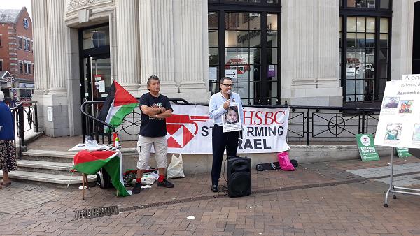 protesters outside HSBC bank with a banner reading 'stop arming Israel'