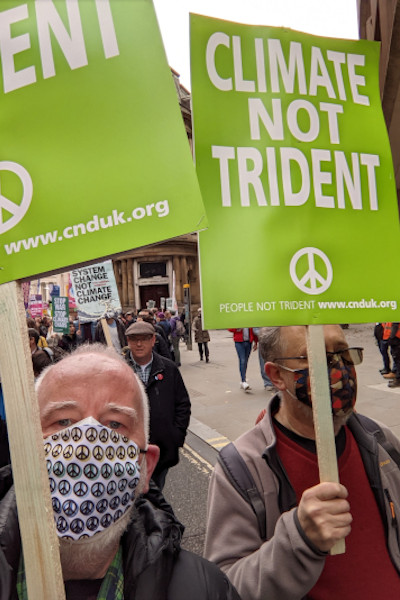 protestor holding placard reading Climate Not Trident