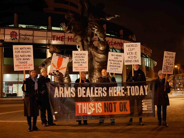 protestors outside the rugby stadium in the dark