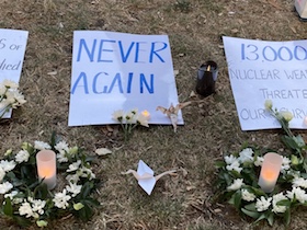 Hiroshima commemorations - Candles and flowers beside the Thames in Canbury Gardens